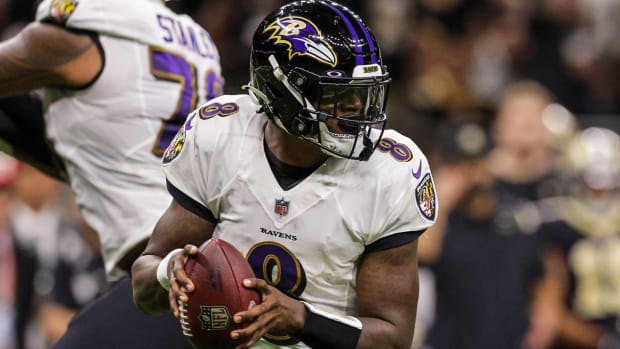 Ravens quarterback Lamar Jackson scrambles to pass in a game vs. the New Orleans Saints.