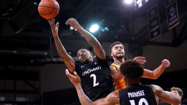 Cincinnati Bearcats guard Landers Nolley II (2) competes for a rebound against Northern Kentucky Norse guard Trey Robinson (1) in the second half during a college basketball game, Wednesday, Nov. 16, 2022, at Truist Arena in Highland Heights, Ky. The Northern Kentucky Norse won, 64-51. Cincinnati Bearcats At Northern Kentucky Norse Nov 16 0057