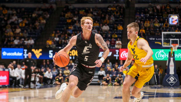 Nov 26, 2021; Morgantown, West Virginia, USA; Eastern Kentucky Colonels guard Cooper Robb (5) drives past West Virginia Mountaineers guard Sean McNeil (22) during the first half at WVU Coliseum.