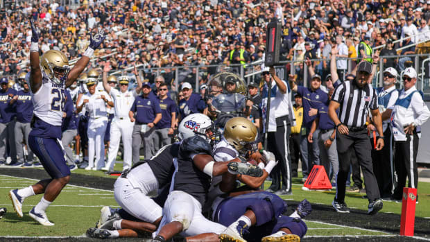 Nov 19, 2022; Orlando, Florida, USA; Navy Midshipmen cornerback Kenneth Hall (22) scores a touchdown during the second quarter against the UCF Knights at FBC Mortgage Stadium. Mandatory Credit: Mike Watters-USA TODAY Sports