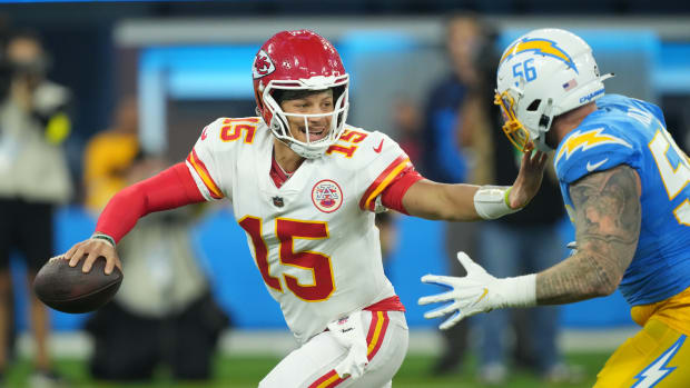 Nov 20, 2022; Inglewood, California, USA; Kansas City Chiefs quarterback Patrick Mahomes (15) is pressured by Los Angeles Chargers defensive end Morgan Fox (56) in the first half at SoFi Stadium. Mandatory Credit: Kirby Lee-USA TODAY Sports