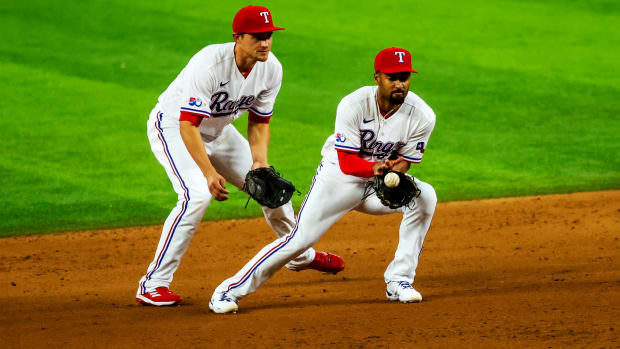 Rangers second baseman Marcus Semien fields a ground ball in front of shortstop Corey Seager.