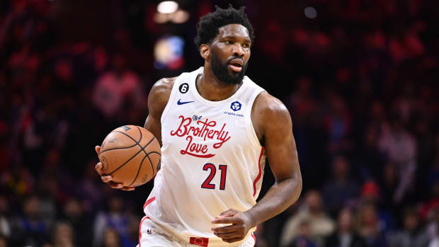 76ers center Joel Embiid (21) dribbles the ball during a game against the Timberwolves.