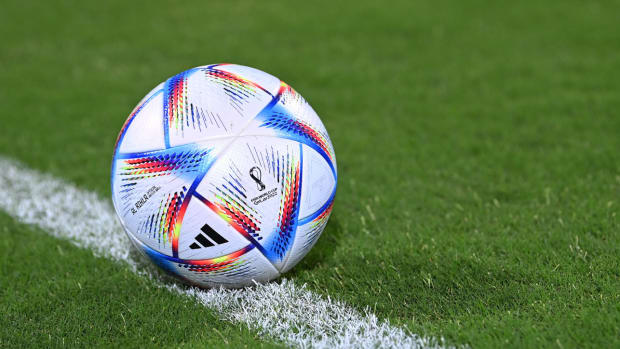 A view of the FIFA World Cup 2022 soccer ball on a field.