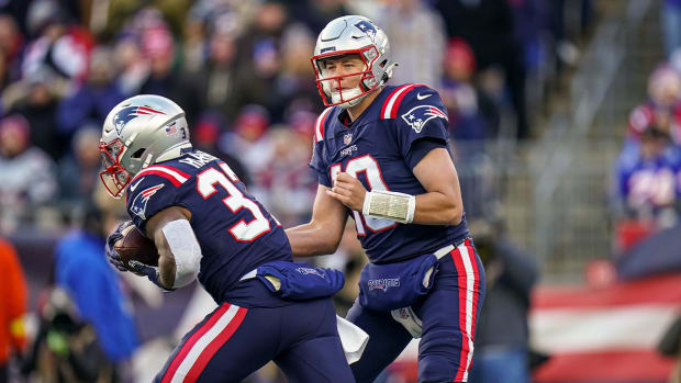 Nov 20, 2022; Foxborough, Massachusetts, USA; New England Patriots quarterback Mac Jones (10) hands off the ball to running back Damien Harris (37) against the New York Jets in the first half at Gillette Stadium.