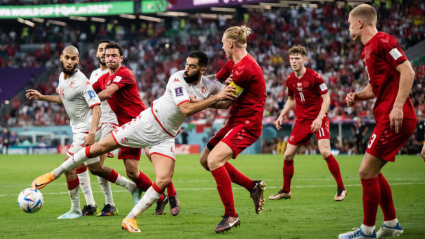Denmark and Tunisia fight for the ball.