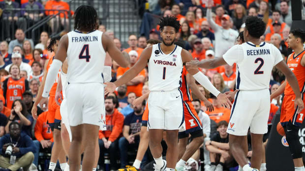 Virginia Cavaliers forward Jayden Gardner (1) celebrates with Virginia Cavaliers guard Armaan Franklin (4) and Virginia Cavaliers guard Reece Beekman (2) after making a play against the Illinois Fighting Illini during the first half at T-Mobile Arena.