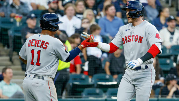 Red Sox second baseman Trevor Story celebrates with third baseman Rafael Devers after hitting a three-run home run.