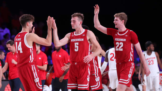 Nov 23, 2022; Paradise Island, BAHAMAS; Wisconsin Badgers forward Carter Gilmore (14) and Wisconsin Badgers forward Tyler Wahl (5) and Wisconsin Badgers forward Steven Crowl (22) celebrate after the game against the Dayton Flyers at Imperial Arena.