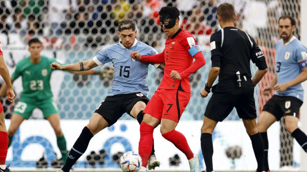 South Korea’s Son Heung-Min works on Uruguay’s Federico Valverde at the World Cup.