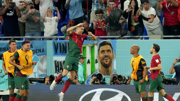 Cristiano Ronaldo pictured jumping in the air to celebrate the goal that made him the first player ever to score at five different FIFA World Cups