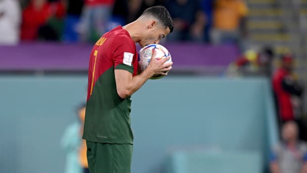 Cristiano Ronaldo pictured kissing the ball before converting a penalty against Ghana to score at his fifth FIFA World Cup for Portugal