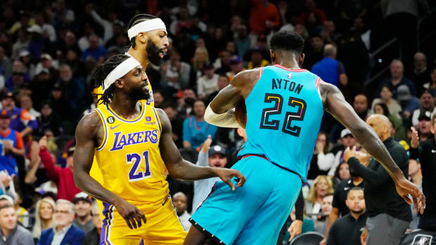 Nov 22, 2022; Phoenix, AZ, USA; Los Angeles Lakers guard Patrick Beverley (21) pushes Phoenix Suns center Deandre Ayton (22) to the court in the second half at Footprint Center. Beverley was ejected from the game.