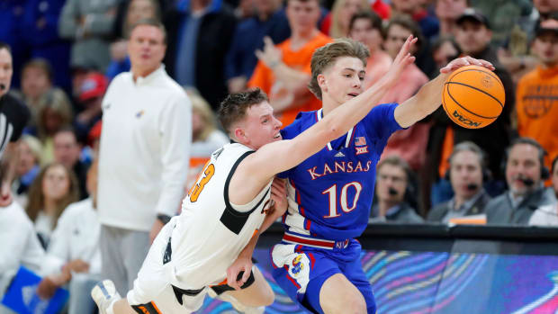 Oklahoma State Cowboys guard Connor Dow (13) reaches for the ball beside Kansas Jayhawks guard Johnny Furphy (10) during a college basketball game between the Oklahoma State University Cowboys (OSU) and the Kansas Jayhawks at Gallagher-Iba Arena in Stillwater, Okla., Tuesday, Jan. 16, 2024. Kansas won 90-66.  