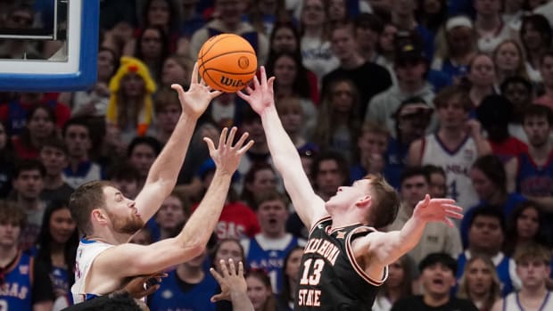Jan 30, 2024; Lawrence, Kansas, USA; Kansas Jayhawks center Hunter Dickinson (1) and Oklahoma State Cowboys guard Connor Dow (13) fight for a rebound during the first half at Allen Fieldhouse. Mandatory Credit: Denny Medley-USA TODAY Sports