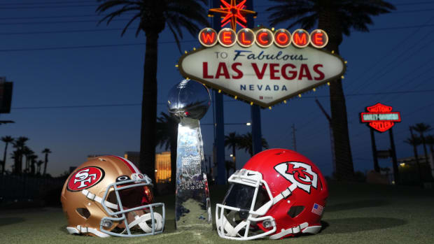 San Francisco 49ers and Kansas City Chiefs helmets with the Lombardi trophy in front of the Welcome to Fabulous Las Vegas sign ahead of Super Bowl LVIII.