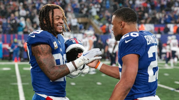 East Rutherford, New Jersey, USA; New York Giants safety Xavier McKinney (29) celebrates with running back Saquon Barkley (26) after a New England Patriots missed field goal during the fourth quarter at MetLife Stadium.