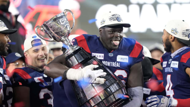Nov 19, 2023; Hamilton, Ontario, CAN; Montreal Alouettes defensive lineman Lwal Uguak (96) cradles the Grey Cup after winning the the 110th Grey Cup against the Winnipeg Blue Bombers at Tim Hortons Field. Mandatory Credit: John E. Sokolowski-USA TODAY Sports  