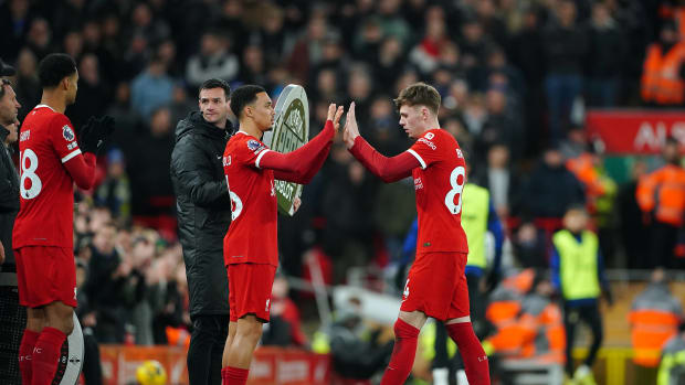 Conor Bradley pictured (right) being substituted off for Liverpool teammate Trent Alexander-Arnold during a 4-1 win over Chelsea in January 2024