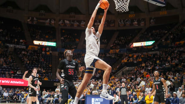 Jan 31, 2024; Morgantown, West Virginia, USA; West Virginia Mountaineers center Jesse Edwards (7) dunks the ball during the second half against the Cincinnati Bearcats at WVU Coliseum. Mandatory Credit: Ben Queen-USA TODAY Sports