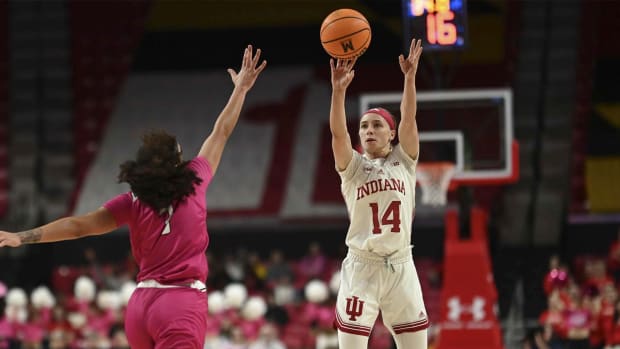 Jan 31, 2024; College Park, Maryland, USA; Indiana Hoosiers guard Sara Scalia (14) shoots a three point basket over Maryland Terrapins guard Lavender Briggs (3) during the first half at Xfinity Center.