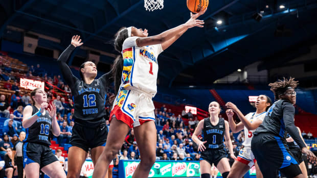 Kansas center Taiyanna Jackson (1) shoots the ball against power forward Lauren Gustin (12) of BYU during a game in Allen Fieldhouse. The Jayhawks defeated the Cougars 67-53.