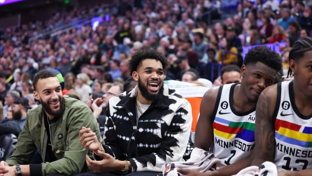 Rudy Gobert, Karl-Anthony Towns and Anthony Edwards laugh on the bench