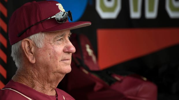 Florida State head coach Mike Martin looks on while in the dugout during a game.