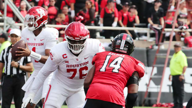 Sep 30, 2023; Lubbock, Texas, USA; Houston Cougars offensive tackle Patrick Paul (76) blocks Texas Tech Red Raiders defensive end Joseph Adedire (14) in the second half at Jones AT&T Stadium and Cody Campbell Field.