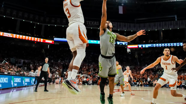 Texas Longhorns guard Max Abmas (3) shoots the ball over defense from Baylor Bears guard Langston Love (13) in the second half of the Longhorns' game against the Baylor Bears at the Moody Center in Austin, Jan 20, 2024. Texas won the game 75-73 with a layup in the final seconds of the game.