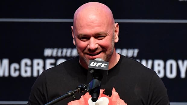 Dana White laughs with a reporter during a UFC press conference.