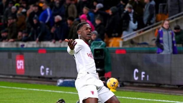 Kobbie Mainoo pictured celebrating after scoring the first goal of his Premier League career to seal a 4-3 win for Manchester United at Wolves in February 2024