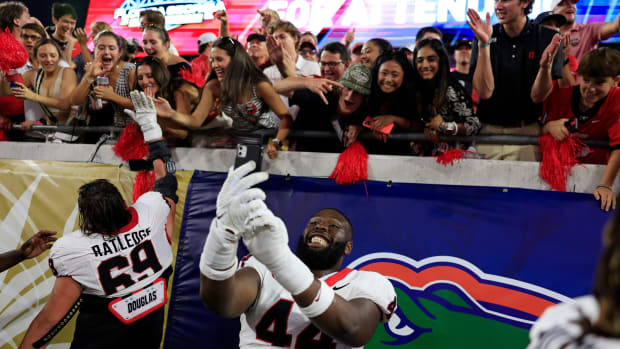 Georgia Bulldogs defensive lineman Jordan Hall (44) takes a selfie for a fan after the game of an NCAA Football game Saturday, Oct. 28, 2023 at EverBank Stadium in Jacksonville, Fla. Georgia defeated Florida 43-20.