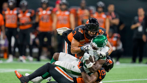 Aug 26, 2022; Vancouver, British Columbia, CAN; BC Lions linebacker Josh Woods (3) and defensive back Delvin Breaux Sr (23) tackle Saskatchewan Roughriders running back Frankie Hickson (20) in the first half at BC Place. Mandatory Credit: Bob Frid-USA TODAY Sports  