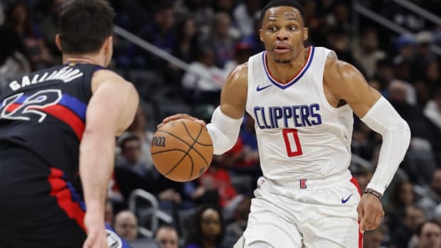 Feb 2, 2024; Detroit, Michigan, USA; LA Clippers guard Russell Westbrook (0) dribbles defended by Detroit Pistons forward Danilo Gallinari (12) in the first half at Little Caesars Arena. 
