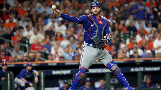 Texas Rangers catcher Jonah Heim throws to first for an out during the sixth inning of Game 7 of the ALCS against the Houston Astros at Minute Maid Park.