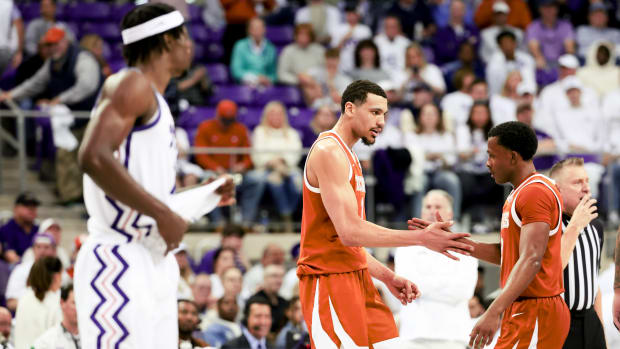 Feb 3, 2024; Fort Worth, Texas, USA; Texas Longhorns guard Max Abmas (3) celebrates with Texas Longhorns forward Dylan Disu (1) in front of TCU Horned Frogs forward Emanuel Miller (2) during the second half at Ed and Rae Schollmaier Arena. Mandatory Credit: Kevin Jairaj-USA TODAY Sports  