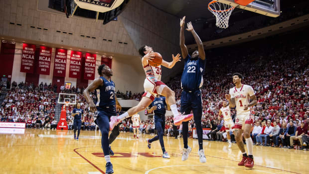  Indiana Hoosiers guard Trey Galloway (32) drives to the basket while Penn State Nittany Lions guard Nick Kern Jr. (3) and forward Qudus Wahab (22) defend at Simon Skjodt Assembly Hall.  