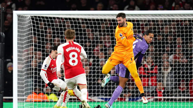 Liverpool goalkeeper Alisson Becker pictured colliding with teammate Virgil van Dijk (right) moments before Gabriel Martinelli (left) scored Arsenal's second goal in a 3-1 win in February 2024