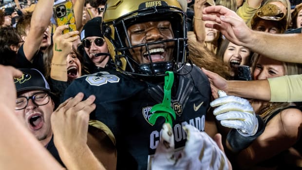 CU football's sophomore defensive end Arden Walker celebrates with students who rushed the field after a thrilling win against CSU in the Rocky Mountain Showdown on Sept. 16, 2023 at Folsom Field in Boulder, Colo.
