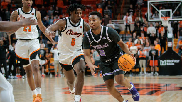 Feb 3, 2024; Stillwater, Oklahoma, USA; Kansas State Wildcats guard Tylor Perry (2) drives around Oklahoma State Cowboys guard Quion Williams (5) during the second half at Gallagher-Iba Arena. Mandatory Credit: William Purnell-USA TODAY Sports