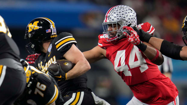 Dec 29, 2023; Arlington, Texas, USA; Ohio State Buckeyes defensive end JT Tuimoloau (44) tackles Missouri Tigers running back Cody Schrader (7) on run in the first quarter during the Goodyear Cotton Bowl Classic at AT&T Stadium.