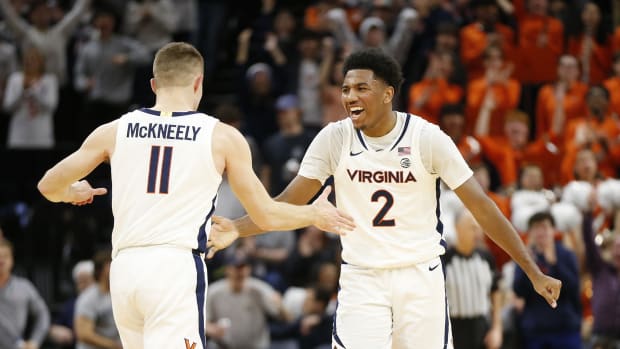 Virginia Cavaliers guard Isaac McKneely (11) celebrates with Cavaliers guard Reece Beekman (2) after scoring against the Notre Dame Fighting Irish during the first half at John Paul Jones Arena.