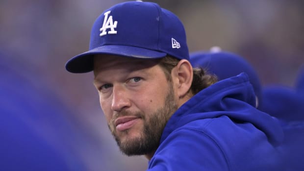 Dodgers starting pitcher Clayton Kershaw looks on in the dugout during a game.