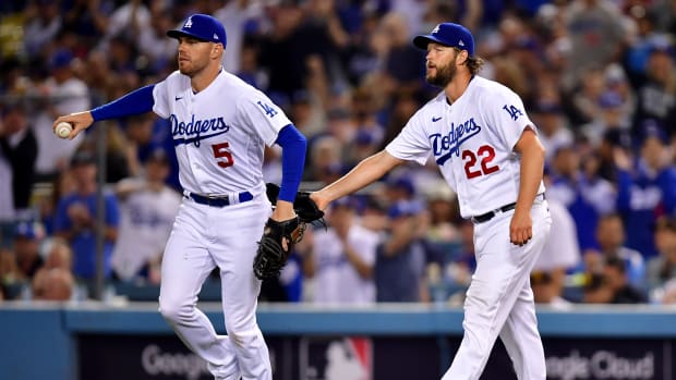 Oct 12, 2022; Los Angeles, California, USA; Los Angeles Dodgers first baseman Freddie Freeman (5) is greeted by pitcher Clayton Kershaw (22) after making an out during the fifth inning of game two of the NLDS for the 2022 MLB Playoffs against the San Diego Padres at Dodger Stadium.