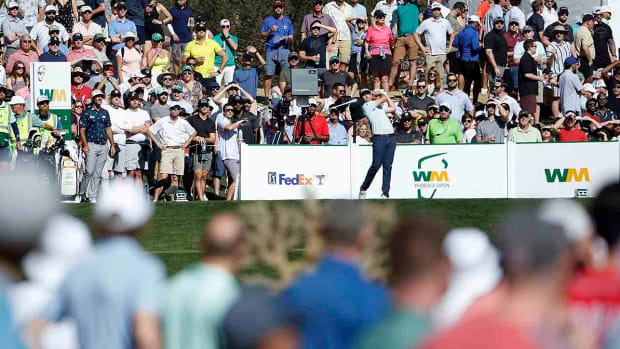 J.T. Poston hits his tee shot on the 12th hole during the third round of the 2022 WM Phoenix Open at TPC Scottsdale in Scottsdale, Ariz.