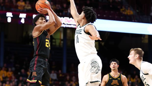 Feb 6, 2024; Minneapolis, Minnesota, USA; Minnesota Golden Gophers guard Cam Christie (24) shoots as Michigan State Spartans guard A.J. Hoggard (11) defends during the first half at Williams Arena.