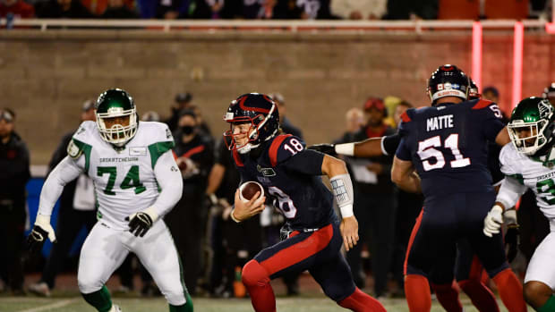 Oct 30, 2021; Montreal, Quebec, CAN; Montreal Alouettes quarterback Matthew Shiltz (18) scrambles away from Saskatchewan Roughriders defensive lineman Makana Henry (74) in the first quarter during a Canadian Football League game at Molson Field. Mandatory Credit: Eric Bolte-USA TODAY Sports  