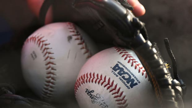 A kid in the stands has a collection of baseballs in his glove as he watches LSU play Arkansas during the SEC Tournament elimination game Thursday, May 25, 2023, at the Hoover Met