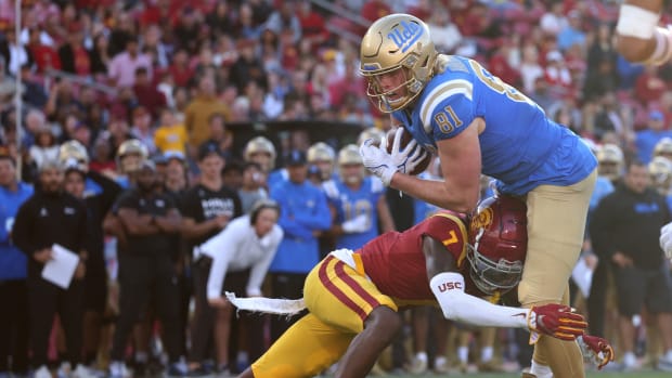 Nov 18, 2023; Los Angeles, California, USA; UCLA Bruins tight end Hudson Habermehl (81) scores a touchdown against USC Trojans safety Calen Bullock (7) during the fourth quarter at United Airlines Field at Los Angeles Memorial Coliseum.